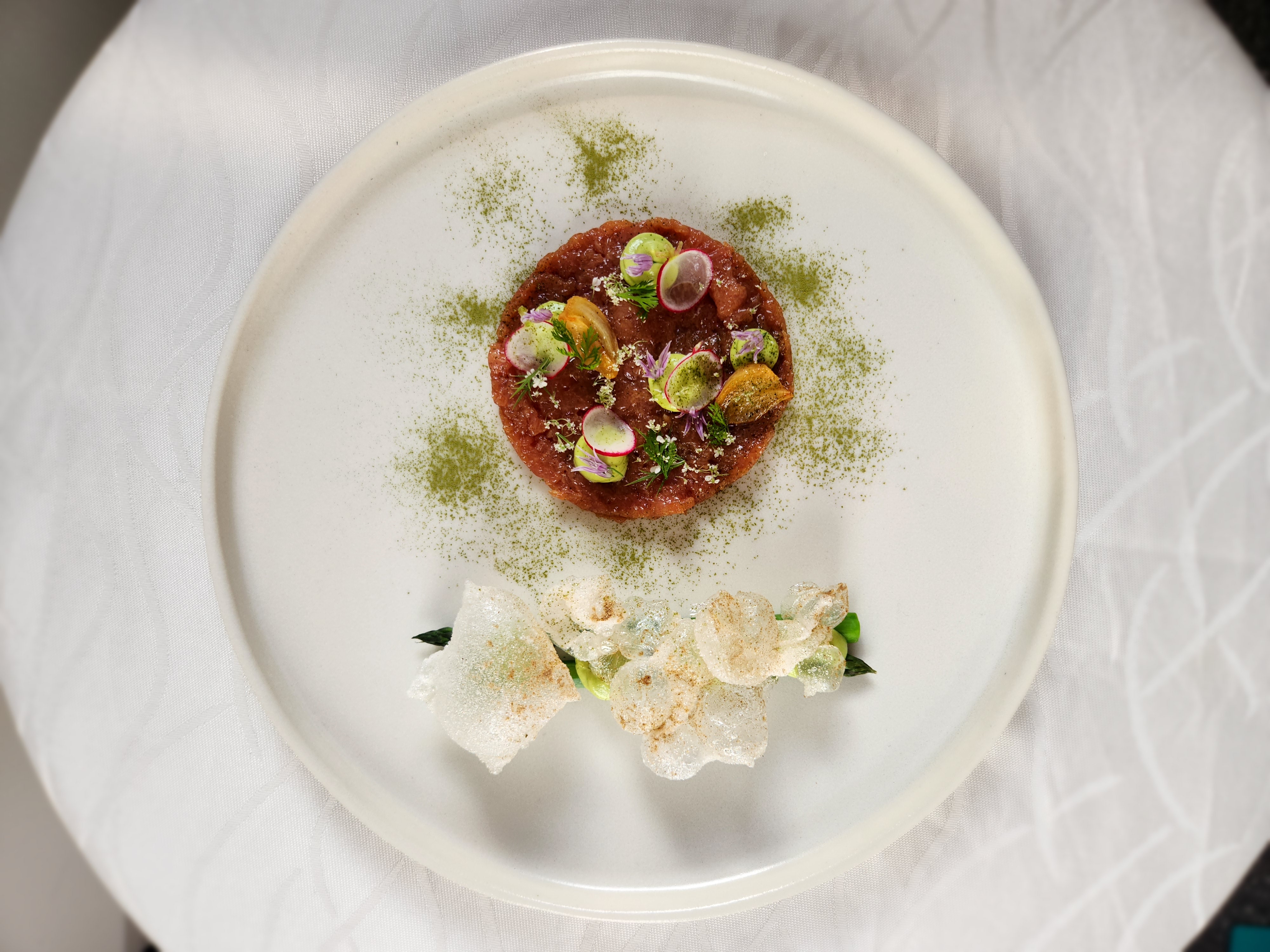 Refined plated tasting course with composed garnish